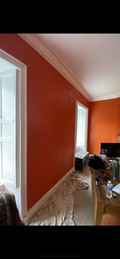 Large lounge walls painted funky colour. 